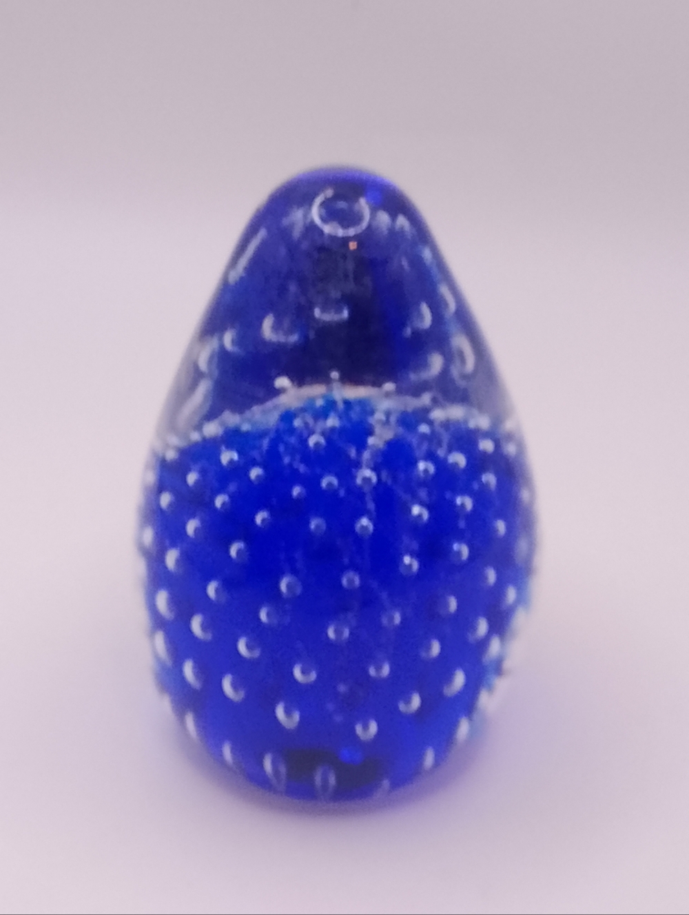 Egg shaped clear/blue controlled bubble clear bottom paperweight 3"